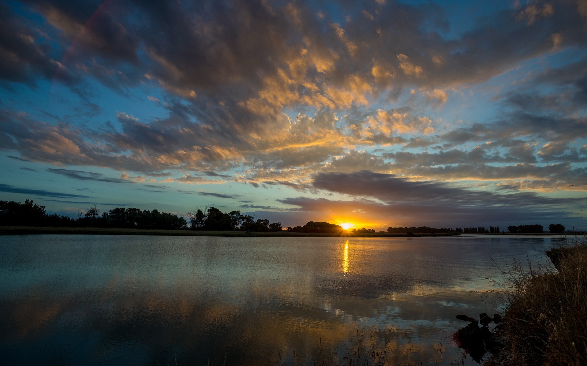 A Calm Lake At Sunset Wallpapers