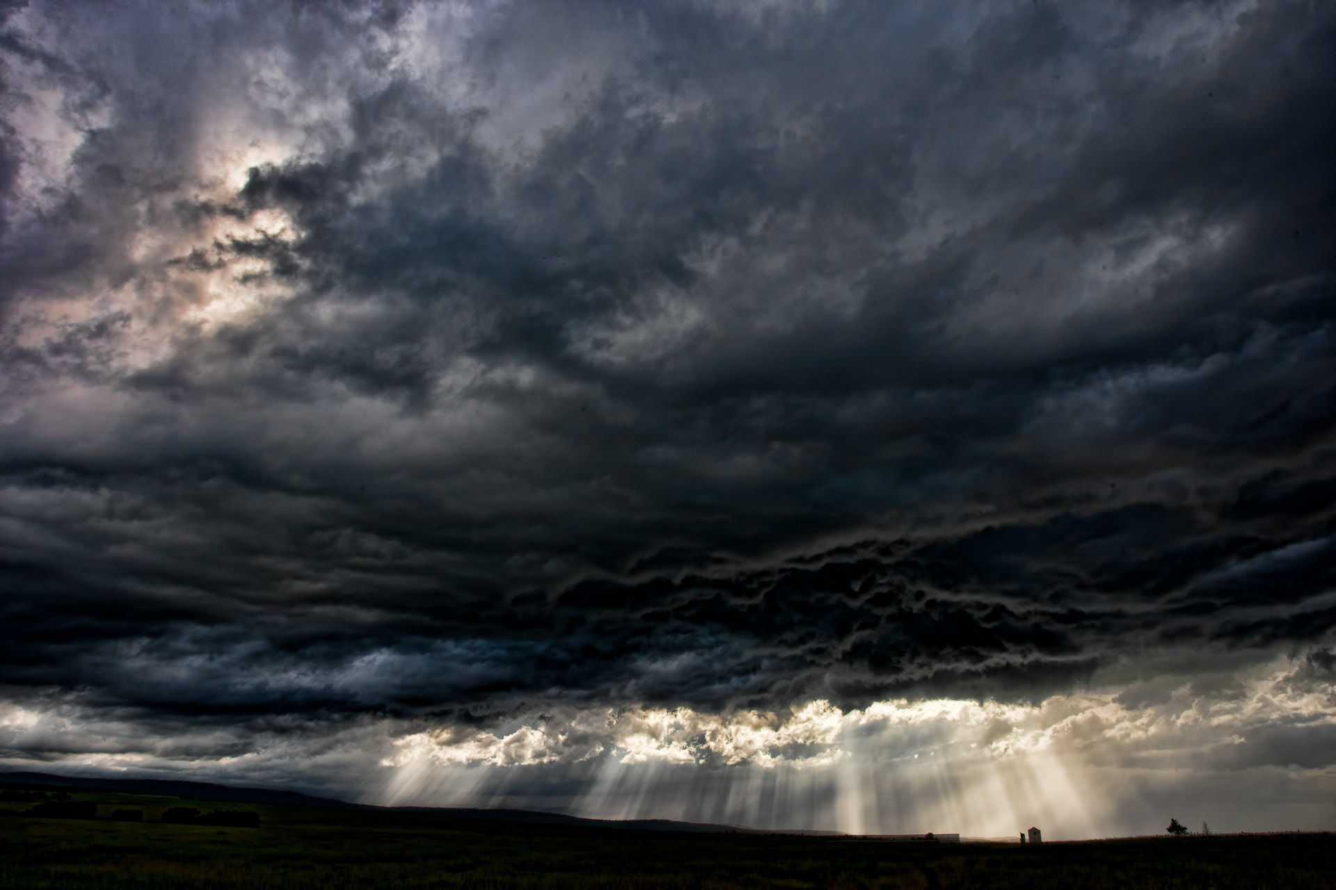 Dramatic Field Under Dark Clouds Wallpapers