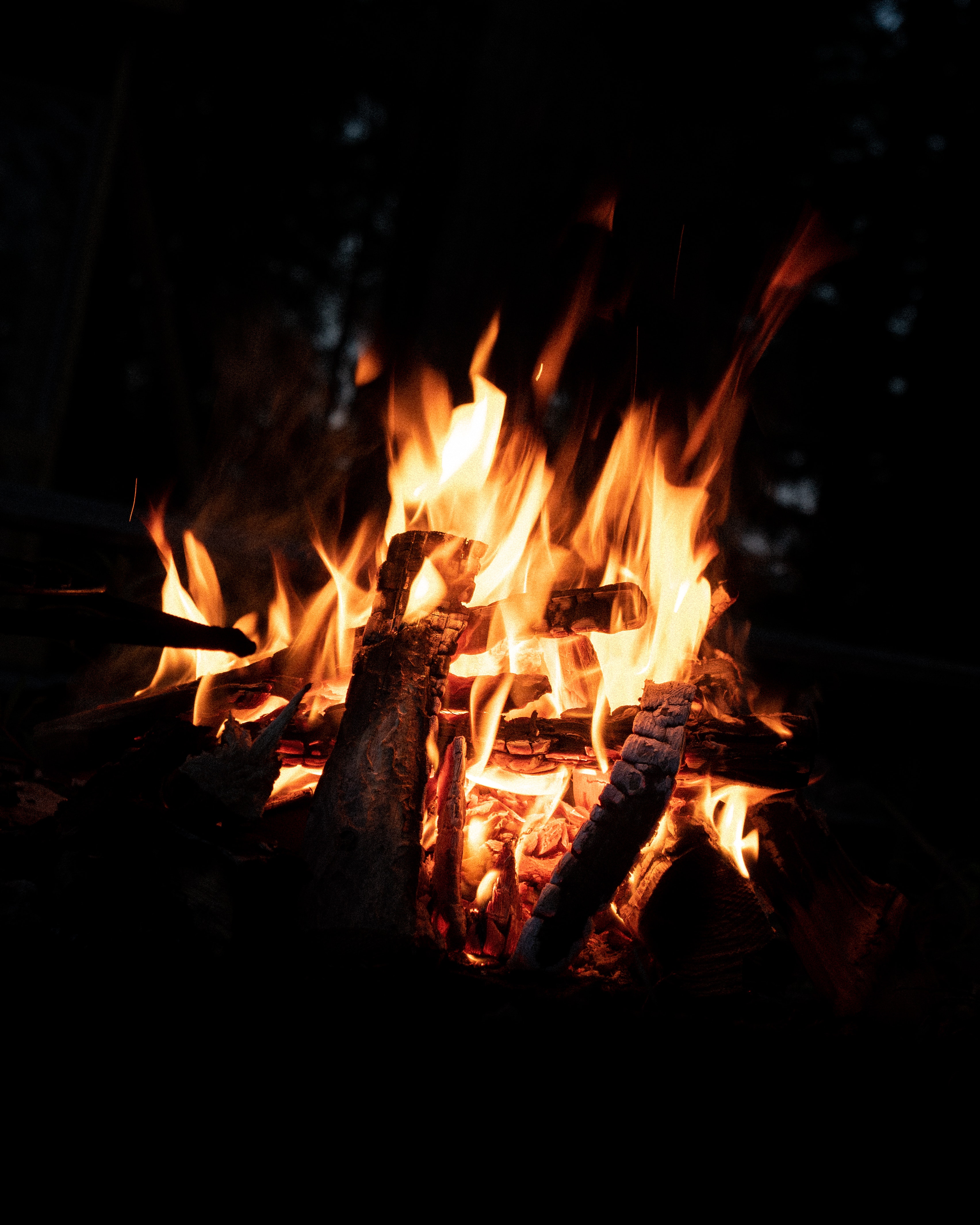 People Sitting Around Campfire In Dark Night Wallpapers