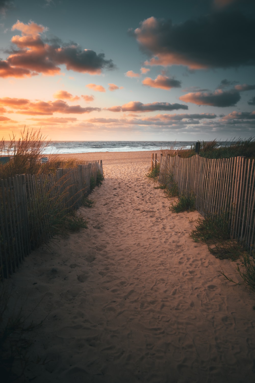 Sand And Pathway To Sea Under Cloudy Sunset Wallpapers
