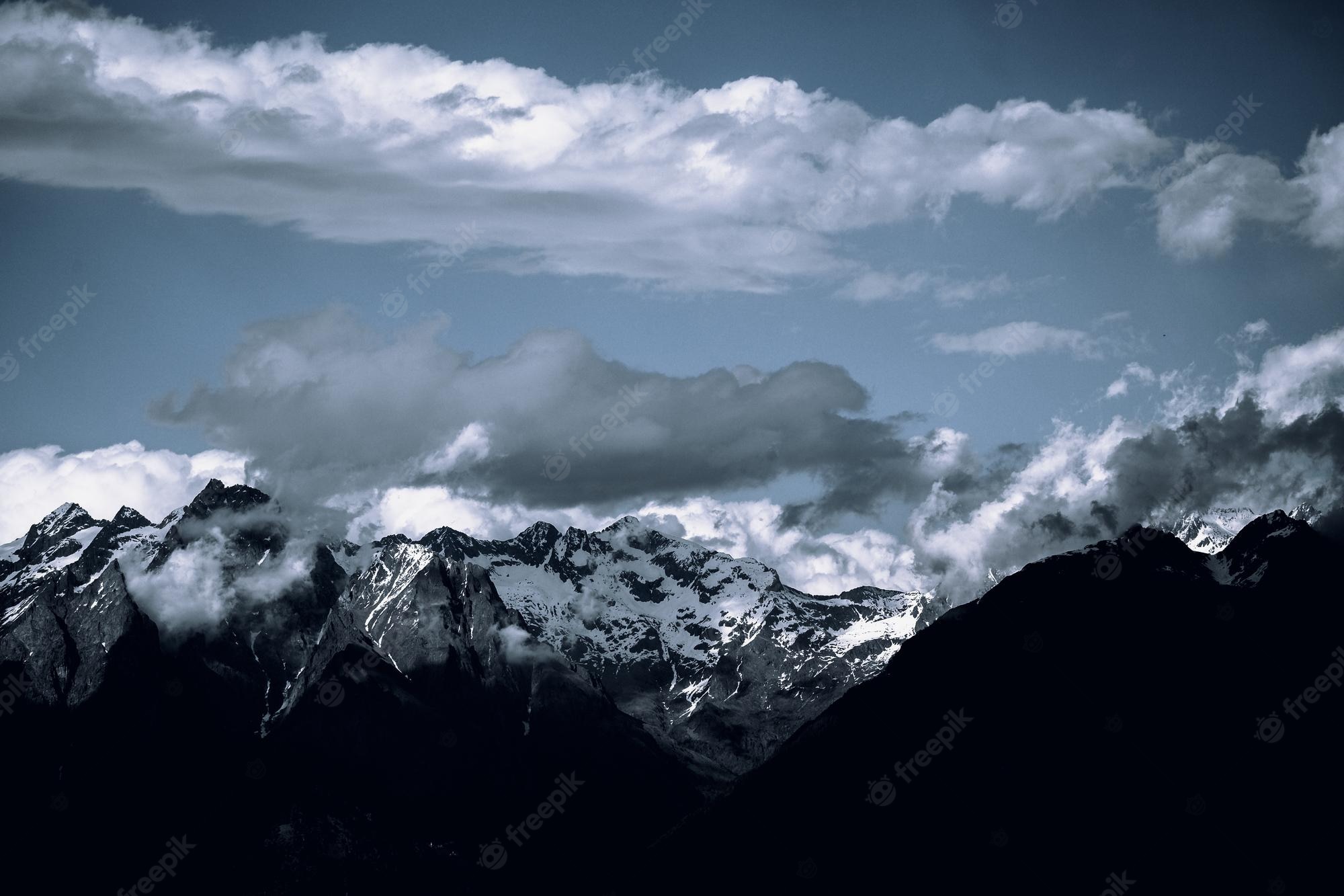 Snow Covered Mountains Under Black Cloudy Sky Wallpapers