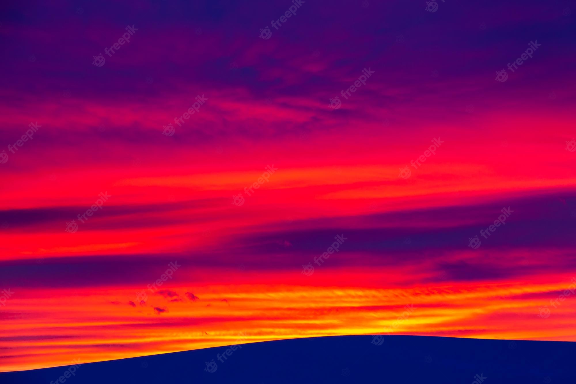 Mountain With Clouds In Background Of Blue And Purple Sky