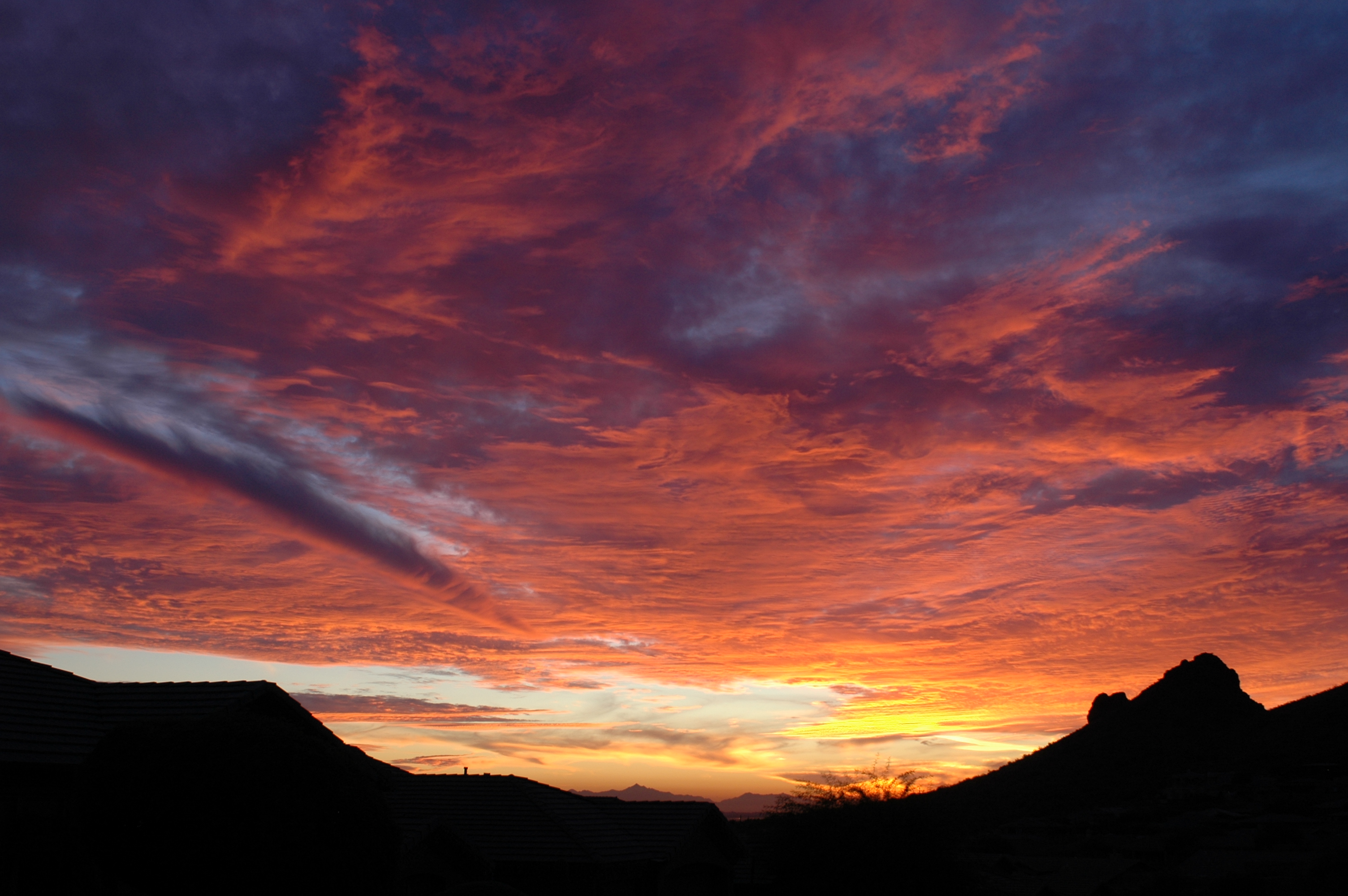 Mountain With Clouds In Background Of Blue And Purple Sky