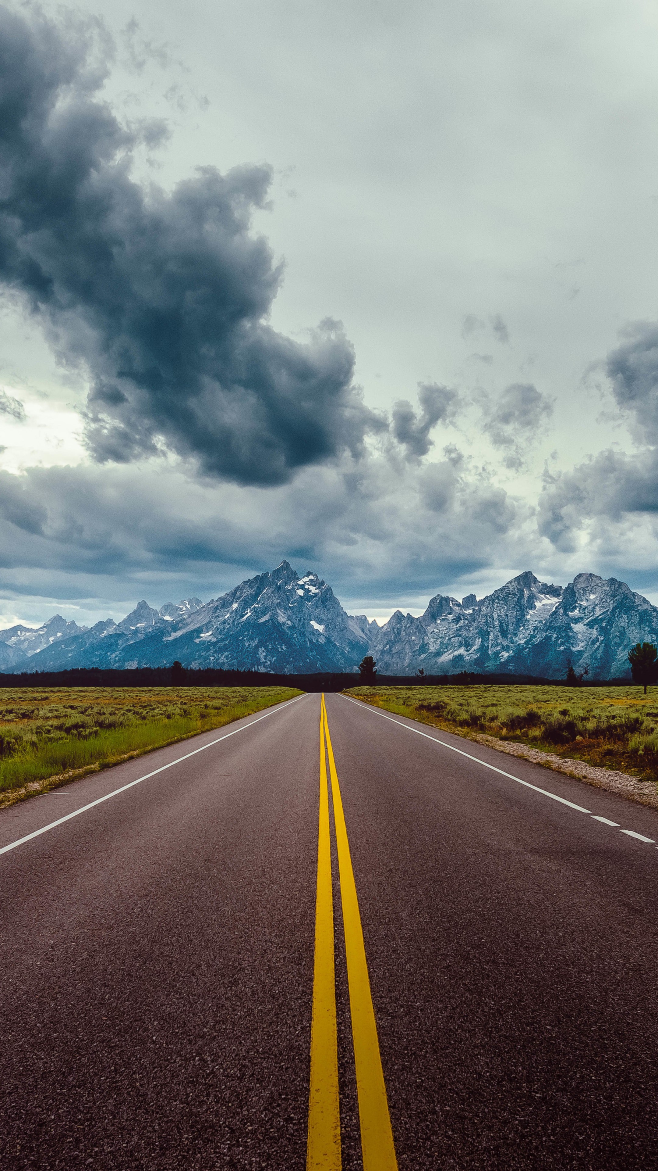 Road With Background Of Mountains And Clouds