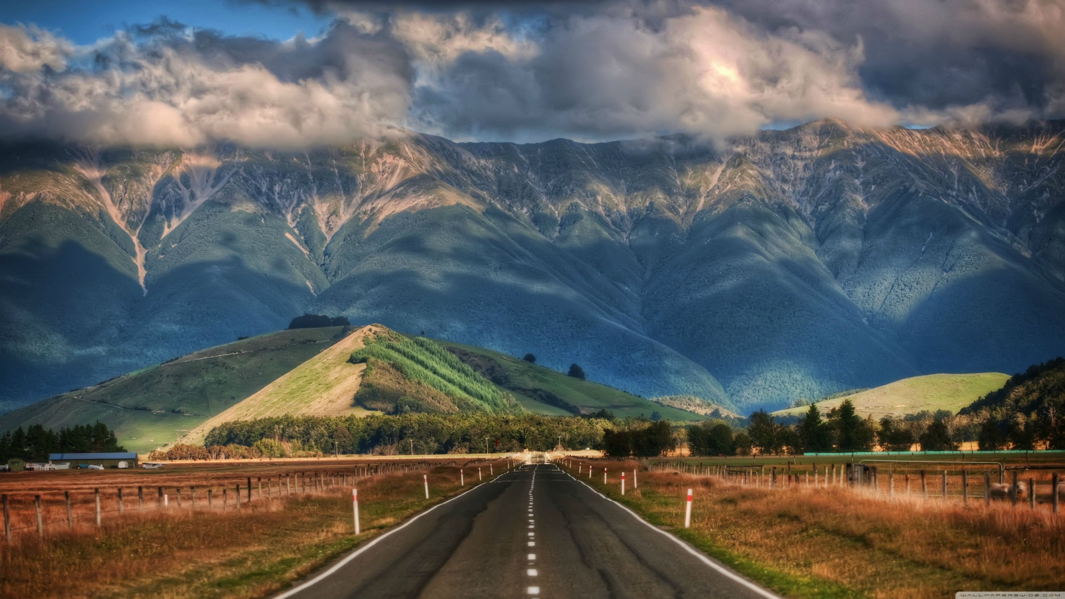 Road With Background Of Mountains And Clouds