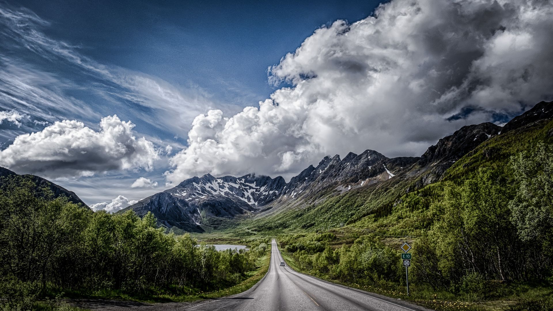 Road With Background Of Mountains And Clouds