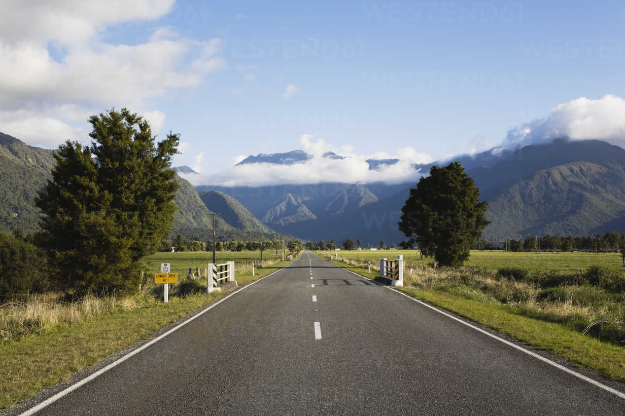 Road With Background Of Mountains And Clouds