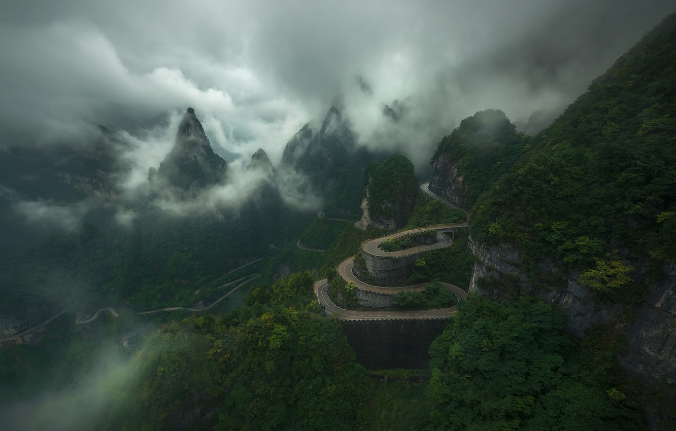 Road With Background Of Mountains And Clouds