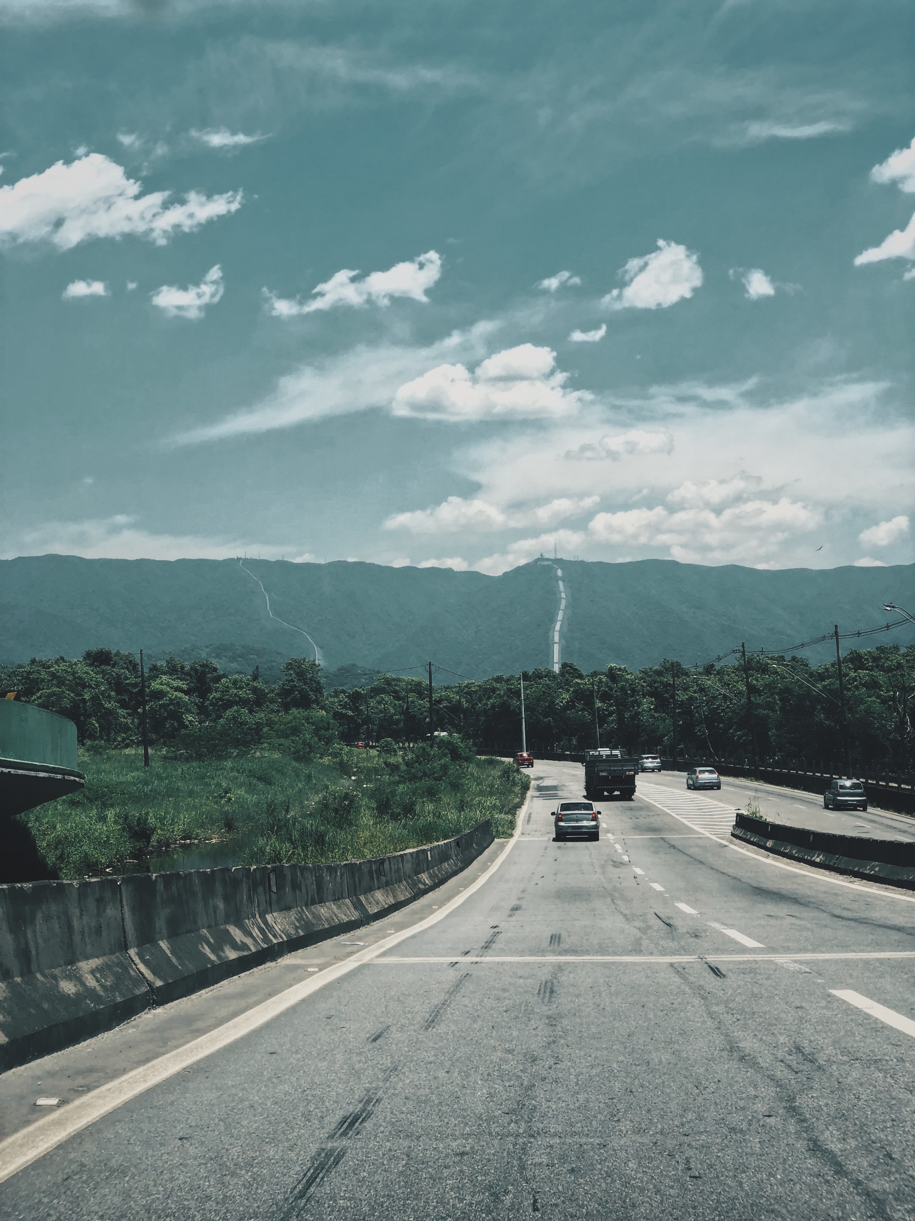 Road With Background Of Mountains And Clouds