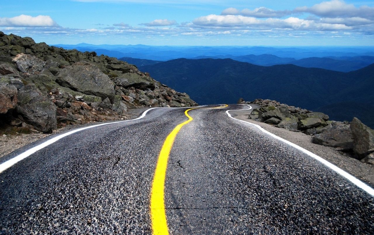 Road With Background Of Mountains And Clouds